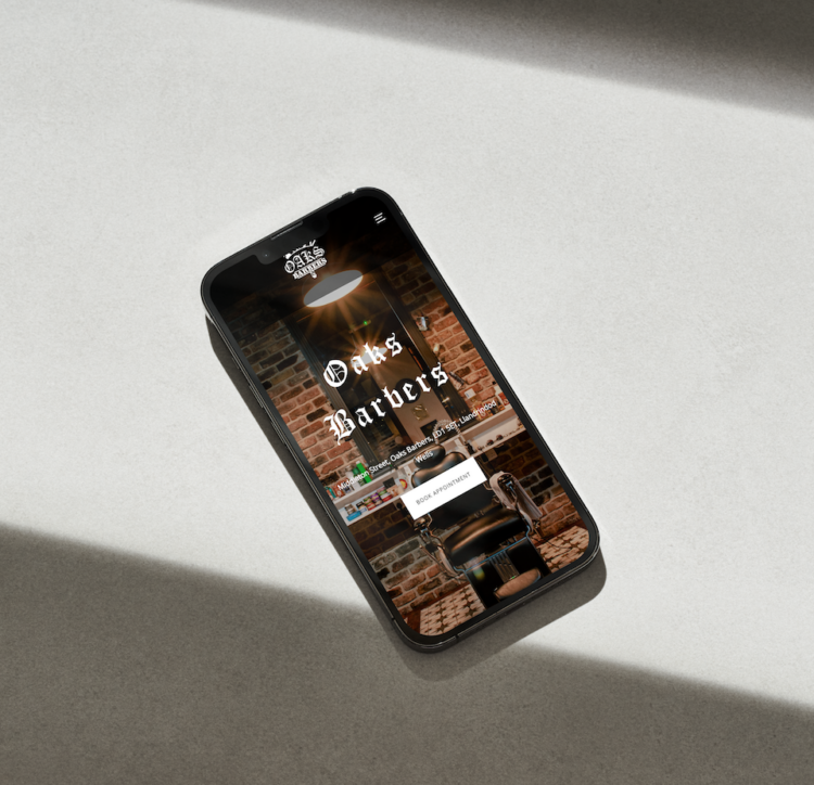 Oaks Barbers Mockup website on an iPhone